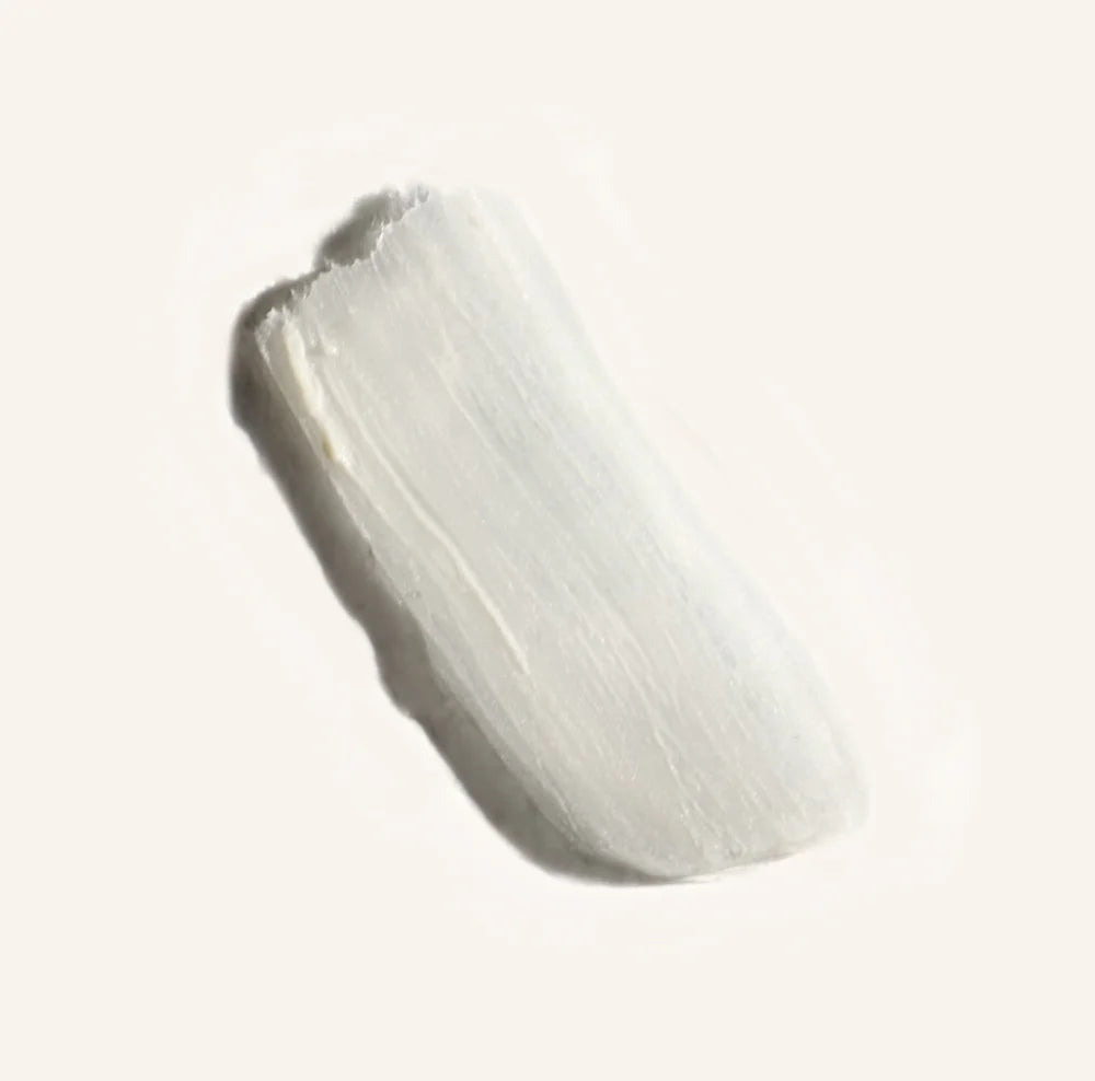 A smear of natural deodorant (white) photographed on a white background.