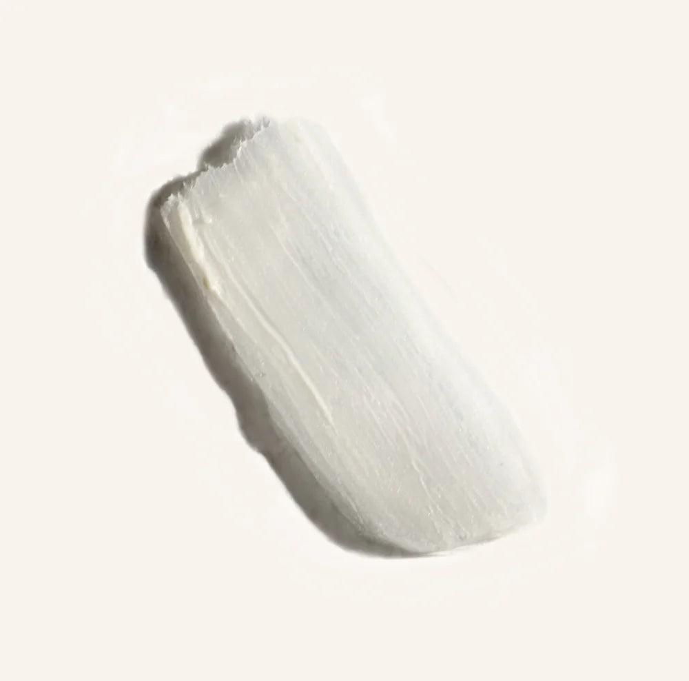 White smear of deodorant photographed on a white background showing the product in action.
