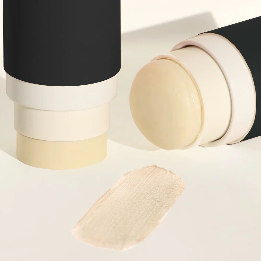 Up close photo of two open black deodorant sticks - Photographed on a white background  with shadows.