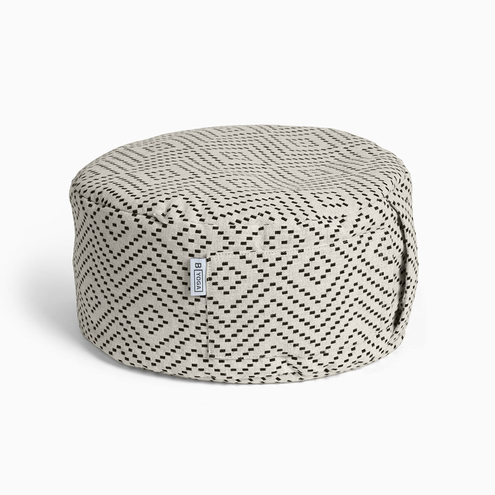 The Calm - Meditation Cushion in beige and black colour - Modern City Day - round modern cushion with removable washable cover photographed close up on a white background