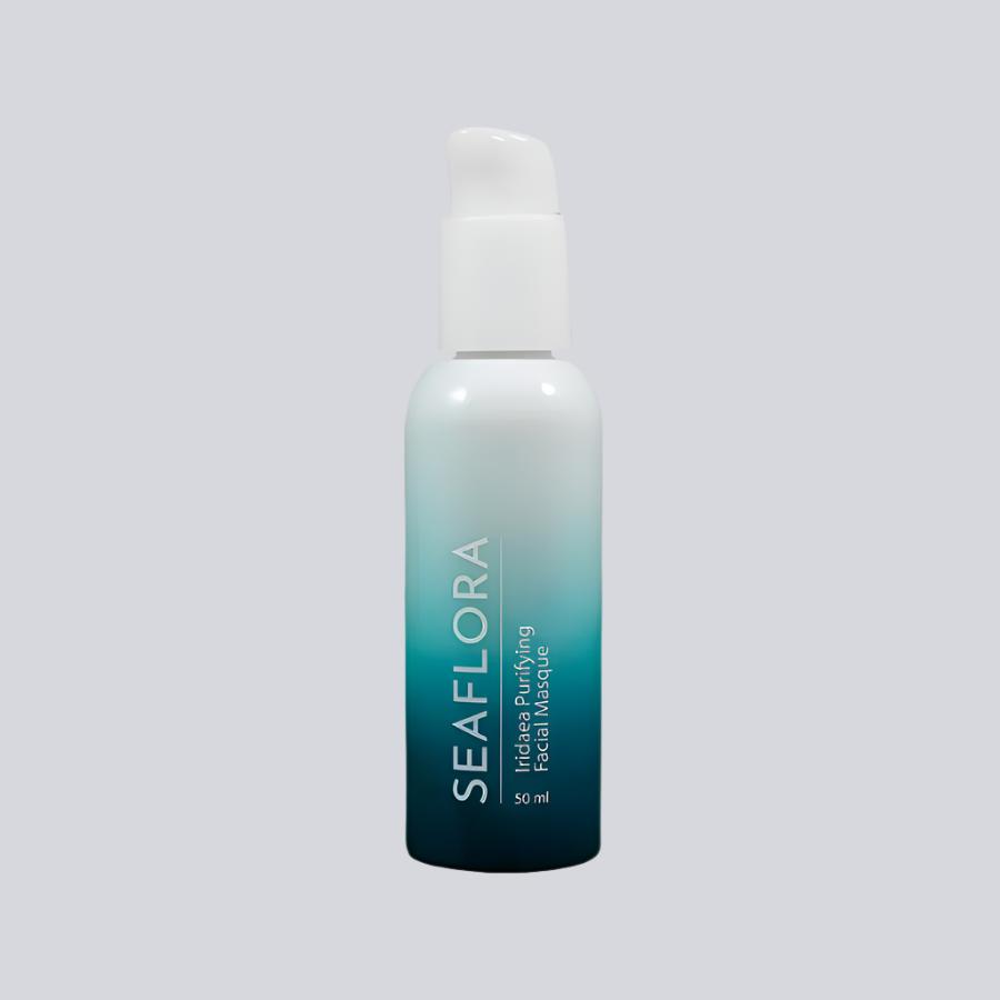 Product shot of Seaflora - Iridaea Purifying Facial Masque shown on a white background - in white fade bottle to aqua and dark aqua - vertical white branding of Seaflora label