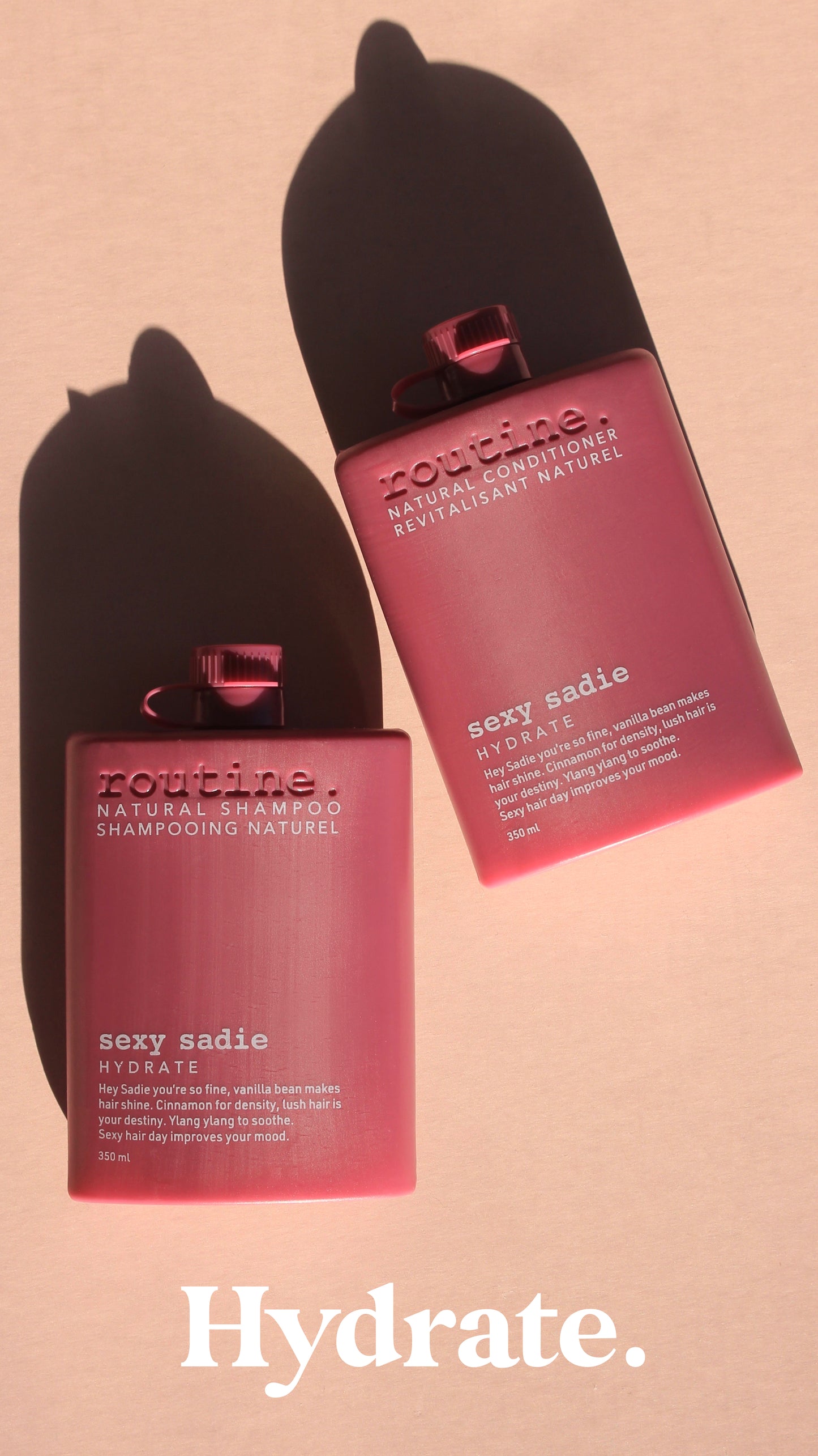 Routine - Natural Shampoo & Conditioner - called Sexy Sadie - Hydrating for your hair - magenta sleek bottle with white writing and pink shadow back ground