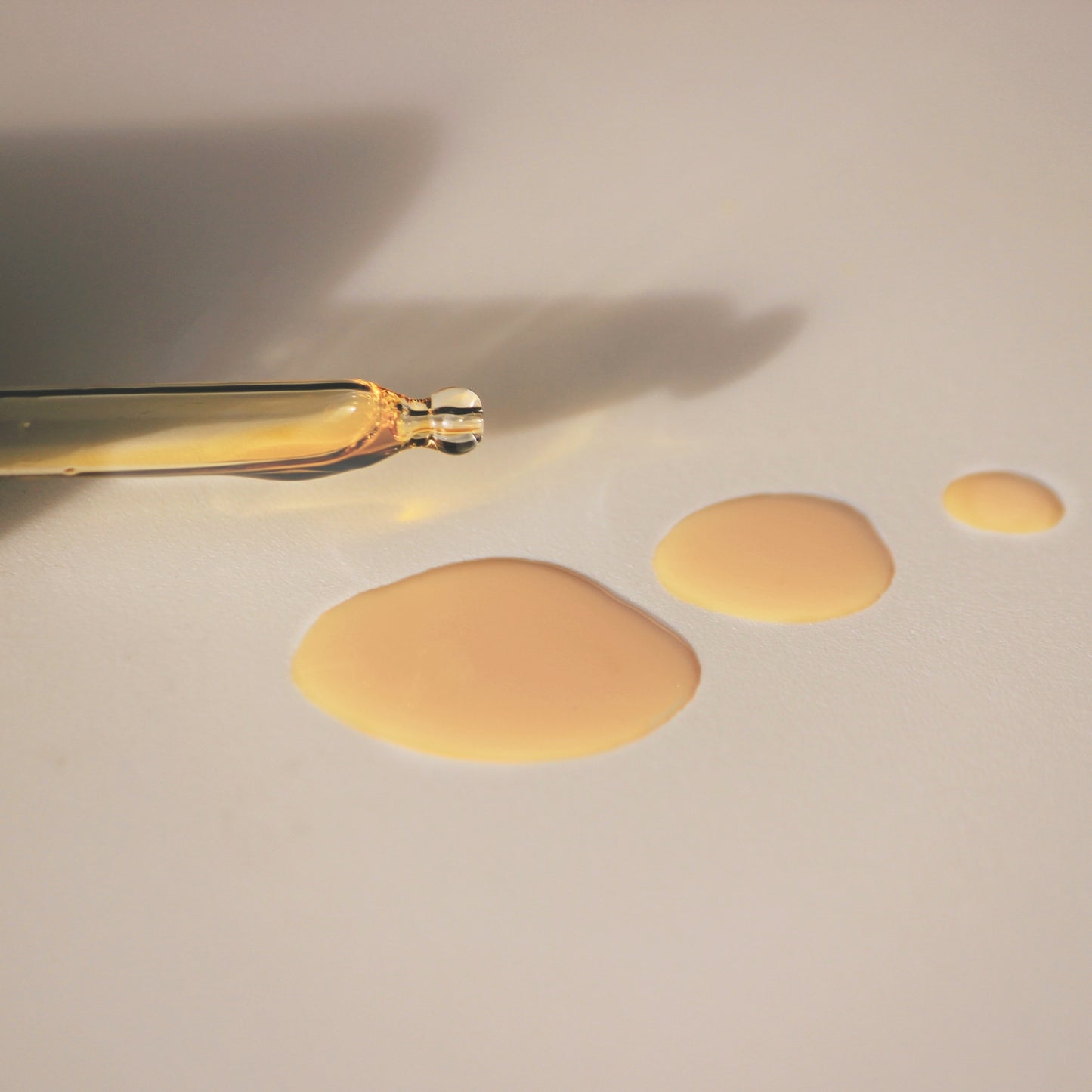 Day oil dropper and three oil drop of "Woke Oil" on a white back ground.