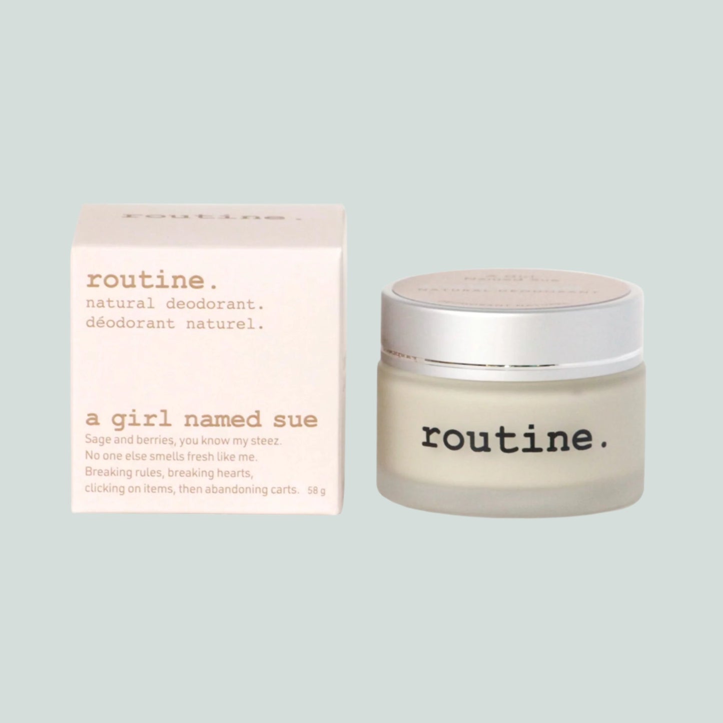 Routine Natural Deodorant Cream - "A Girl Named Sue" scent - showing a white box with a pink hue to it - the label and description of " Routine" - natural deodorant - and a jar of the deodorant to the right of the box - shown on a white background.