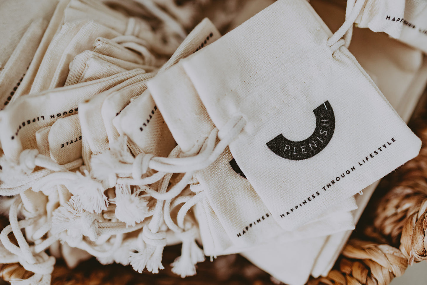 Small Canvas Drawstring - Plenish Brand Mini Travel Bags displayed in a Basket