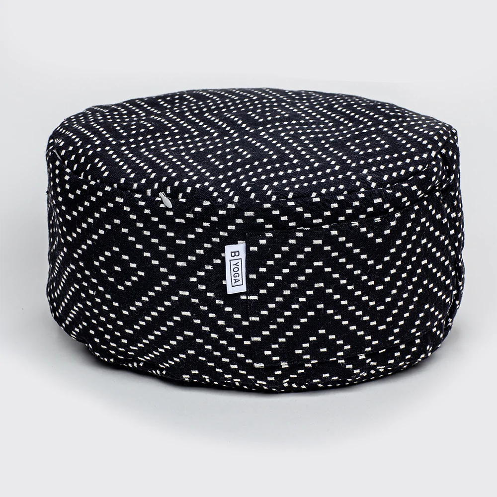 The Calm Meditation Cushion - Modern City Night (black and white diamond pattern white spots on a black round meditation cushion) photographed on a white background