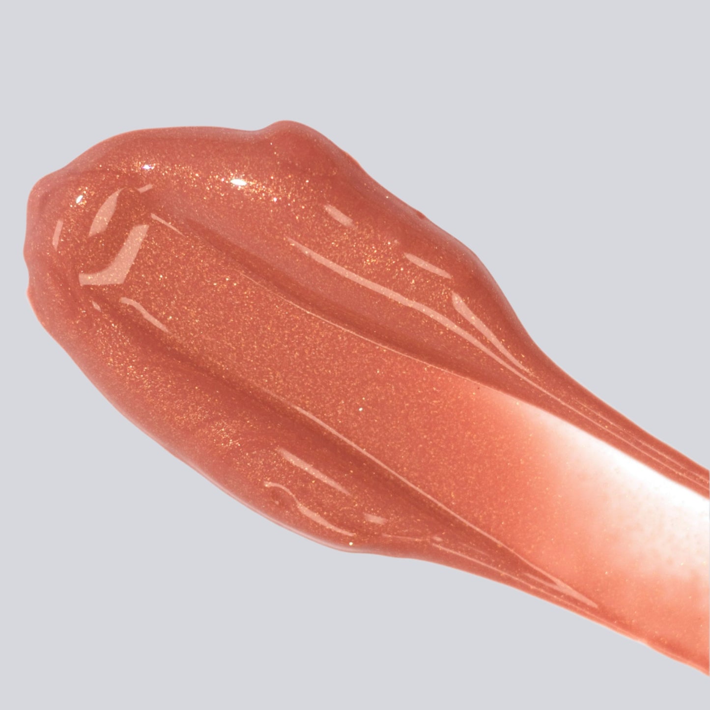 FitGlow Lip Serum - Beach Glow - Sheer Bronze colour  applied as a smear of lip serum onto a white background