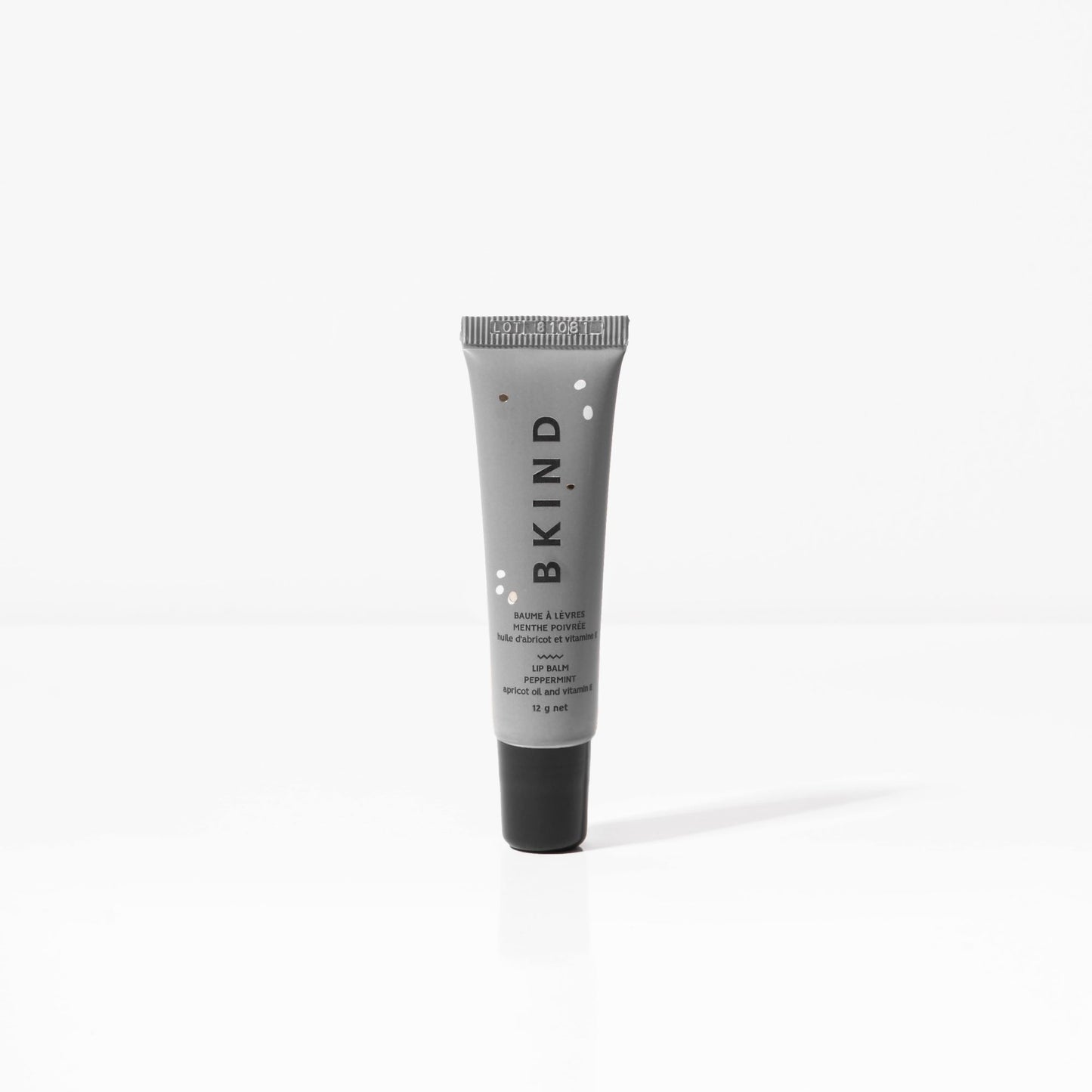BKIND natural vegan lip balm - Peppermint  - small grey tube of BKIND lip balm with a black lid standing upright and displayed on a white background.