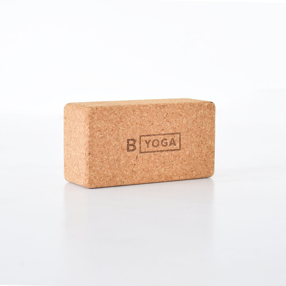B YOGA cork block - photographed with a clean white background with B YOGA logo imprinted in the middle of the block.