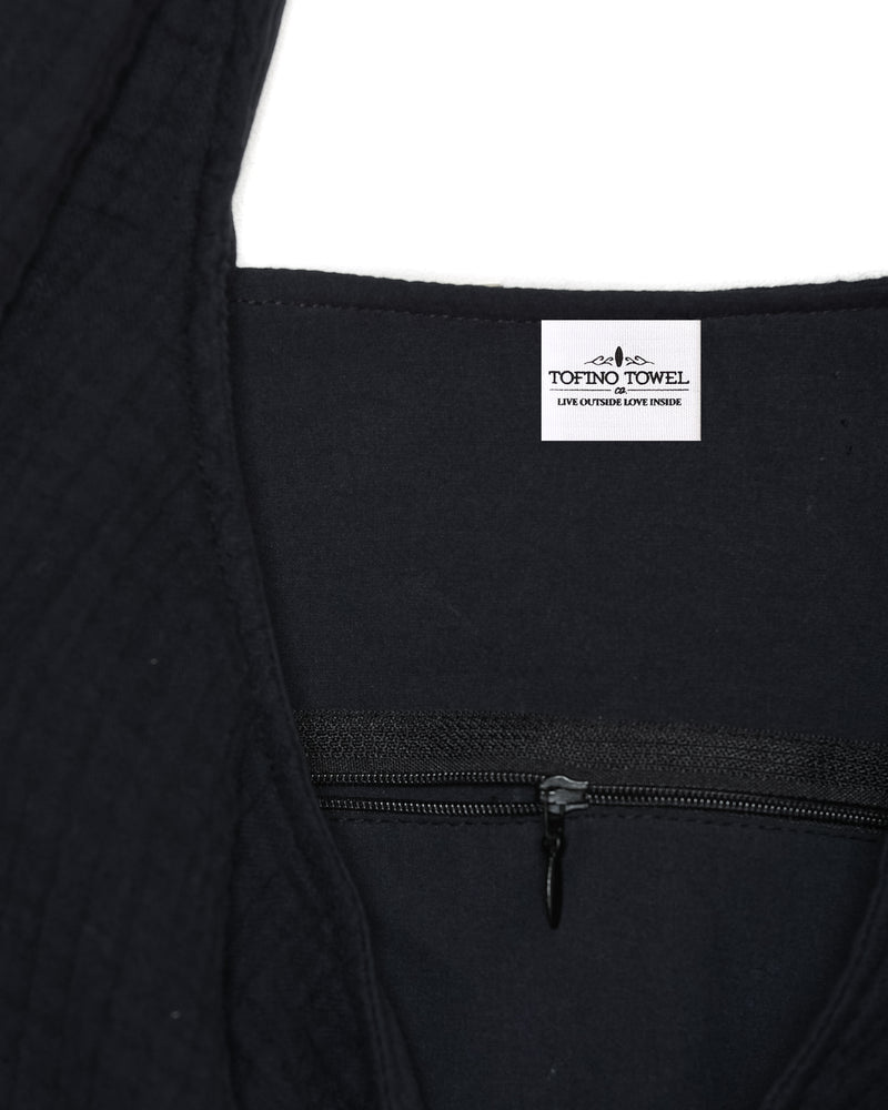
                  
                    Close up of Tofino Towel Label - Live outside Love inside - sewn inside of the Aeline Saddle Bag with inside zipper pocket
                  
                