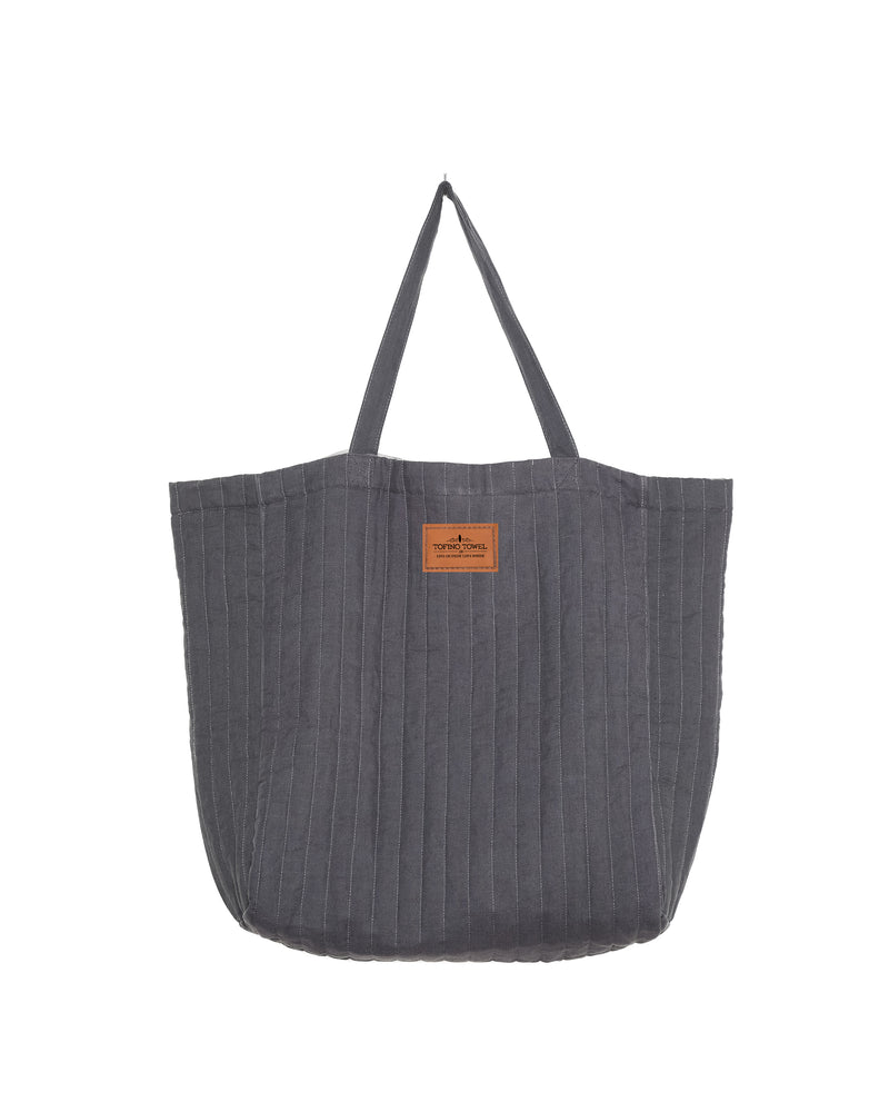 
                  
                    Charcoal ESME oversized quilted tote - photographed on a white background with tan label of Tofino Towel
                  
                
