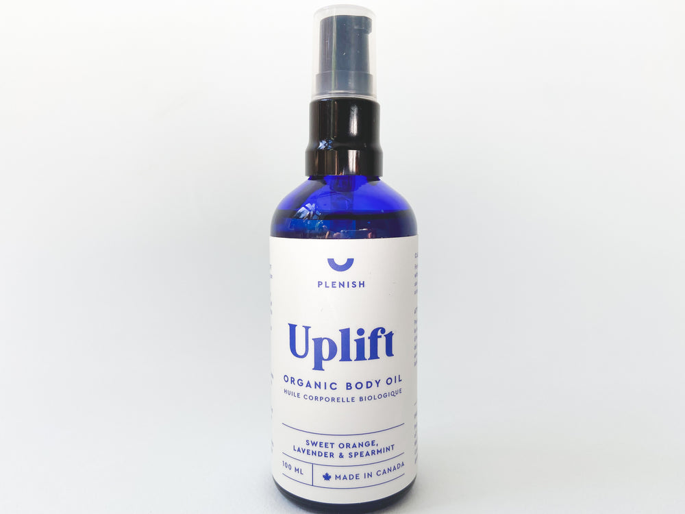 
                  
                    A close up photo of UPLIFT organic body oil - Sweet Orange, Lavender & Spearmint in a 100mL blue bottle with a white label and black pump cap.
                  
                