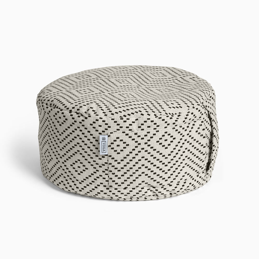 The Calm - Meditation Cushion in beige and black colour - Modern City Day - round modern cushion with removable washable cover photographed close up on a white background 