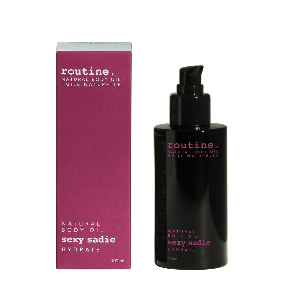 
                  
                    Magenta Box labelled ROUTINE body oil serum - SEXY SADIE - hydrate beside a black sleek bottle with magenta printing on it. Pump top included on the bottle. Clean white background.
                  
                