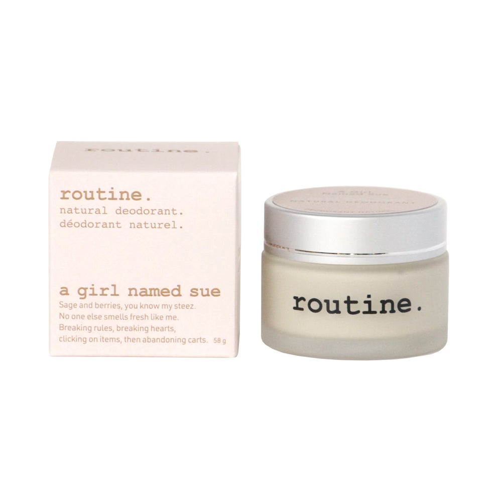 Routine Natural Deodorant Cream - "A Girl Named Sue" scent - showing a white box with a pink hue to it - the label and description of " Routine" - natural deodorant - and a jar of the deodorant to the right of the box - shown on a white background.