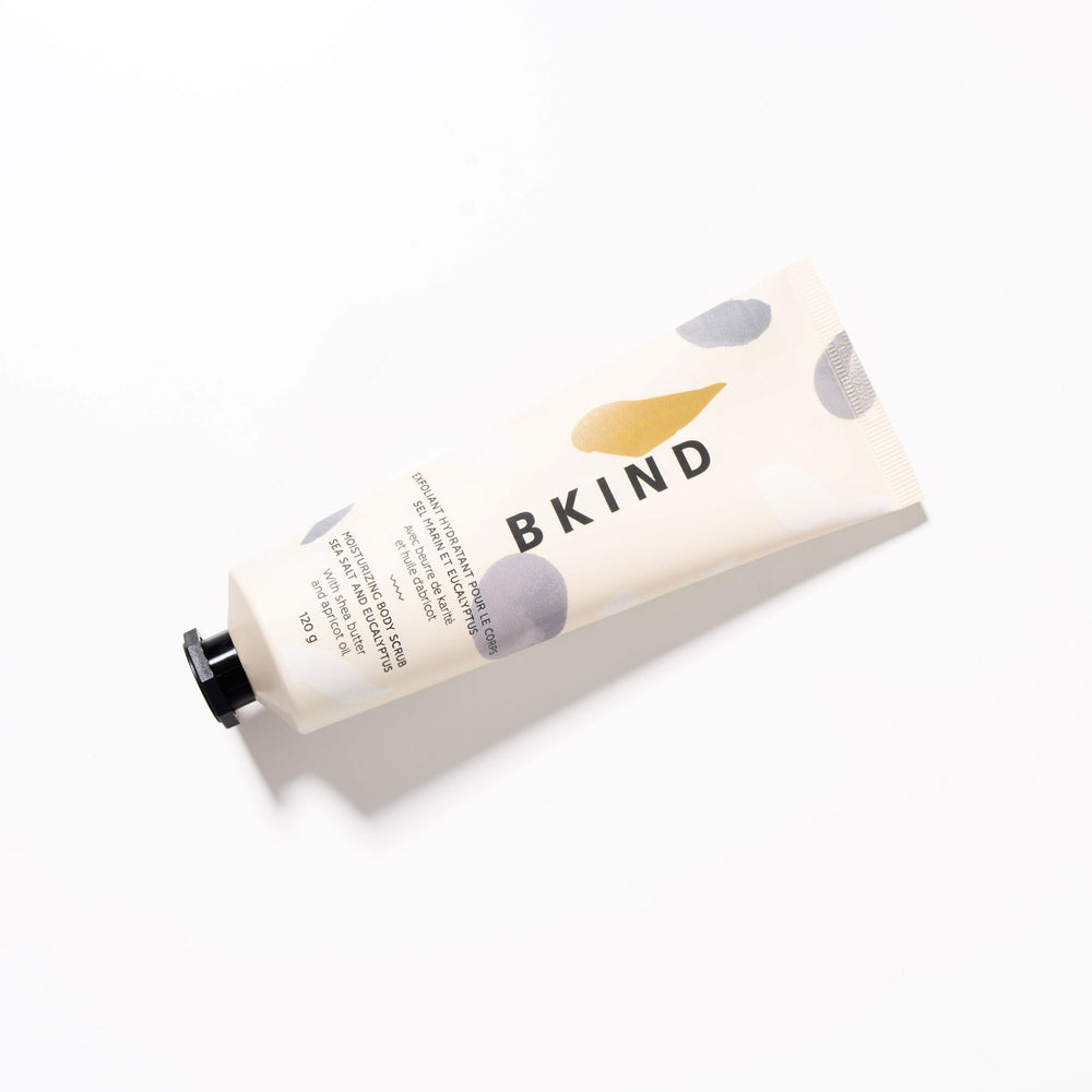 BKIND sea salt and eucalyptus moisturizing scrub in a beige tube with powder blue designs on the tube - displayed on a white background. 